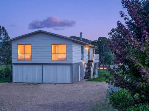 a house with a garage with its lights on at Mudita at Bonnie Doon in Bonnie Doon