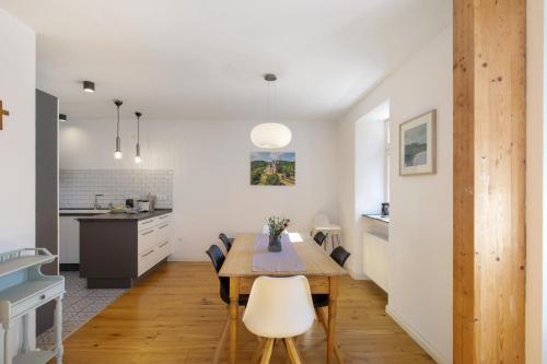 a kitchen and dining room with a table and chairs at Eifel with Family in Thür