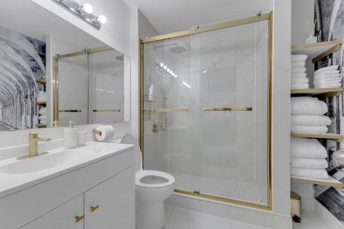 a bathroom with a shower and a toilet and a sink at Guest House in Calgary Downtown in Calgary