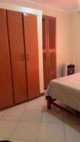 a bedroom with orange lockers and a bed at Malaika Villas in Kampala