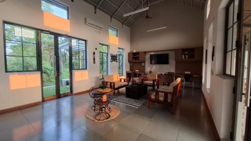 a large living room with a table and chairs at Moner Pukur in Bolpur