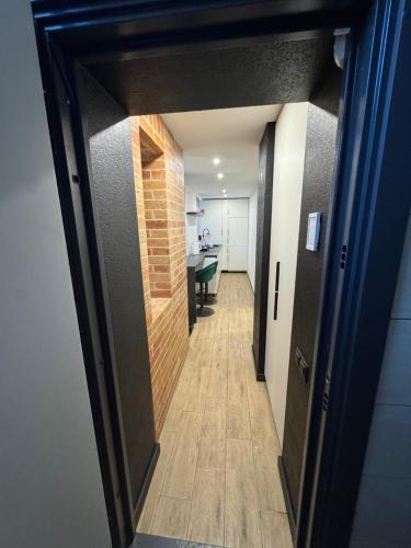 a hallway leading to a room with a brick wall at Historical Apartments by Stepan Fedak in Lviv
