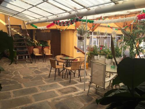 a patio with tables and chairs in a building at Habitaciones Betito in Mazamitla