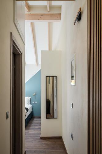 a room with a mirror on the wall and a bed at MustBe CFU Studios in Danilia