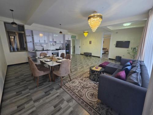 a living room with a couch and a table at Goldsip lounge in Dirē Kʼalu