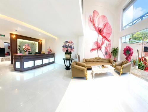 a large living room with flowers on the wall at Love Luxury Hotel Bà Điểm in Ho Chi Minh City