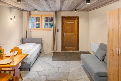 a living room with a couch and a table at Studio chaleureux au coeur d'un chalet alpin in Zinal