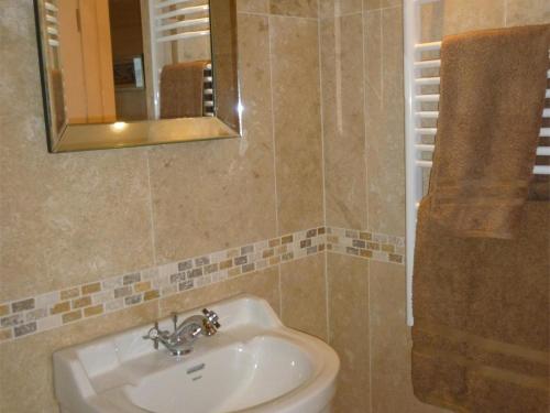 a bathroom with a sink and a mirror at 1 Bed in Isle Of Arran oc-ca344 in Kilmory