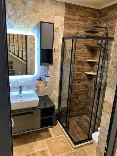 a bathroom with a shower and a sink and a shower at RCR The Stones in Flogita