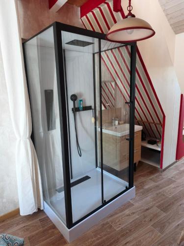 a glass shower in a room with a staircase at Ty Capitaine Chambres d'hôtes Guidel in Guidel