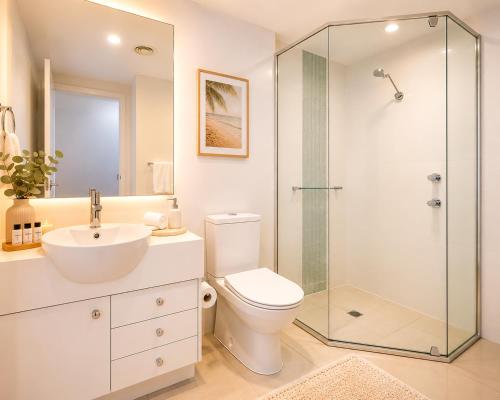 a bathroom with a toilet and a glass shower at Newly Restyled Resort Studio Oaks Pacific Blue in Salamander Bay