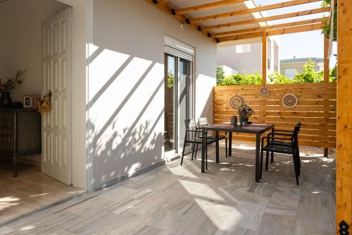 a patio with a table and chairs on it at Filerimos Nest - Private Countyard in Pastida