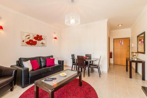 a living room with a couch and a table at Vandalou By ALzira in Albufeira