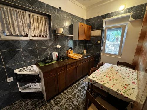 a kitchen with a counter and a table in it at Stone Villa in Bečići
