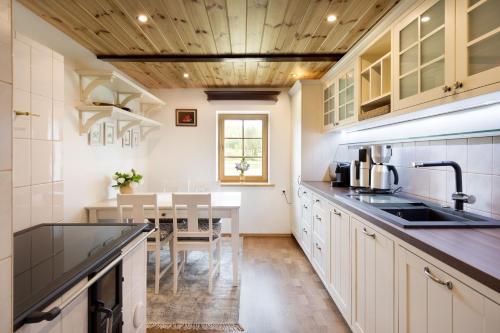 a kitchen with a sink and a table in it at Tabina puhkemaja in Tabina