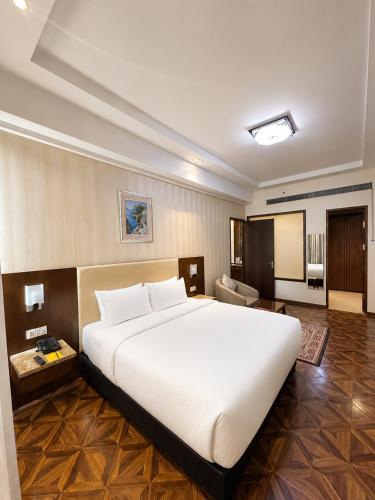 a large white bed in a hotel room at Golden Tulip Kukas Jaipur in Jaipur