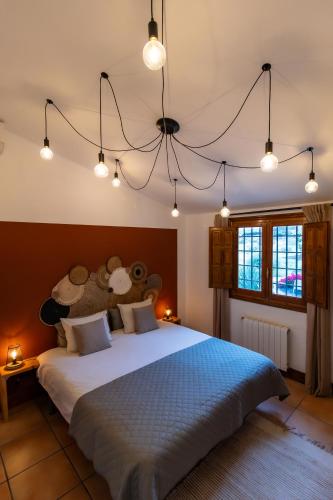 a bedroom with a large bed with a teddy bear on it at Casa Sabor de la Vida in Abarán