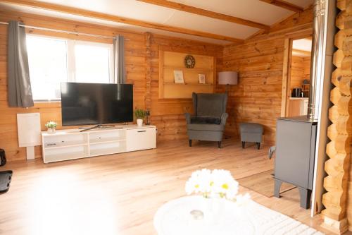 a living room with a large flat screen tv at Ferienhaus Wasserläufer Bellin in Ueckermünde