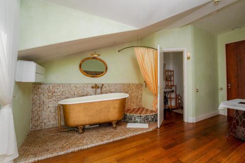 a large bathroom with a large tub in a room at Divas Upes SPA hotel Koknese in Koknese