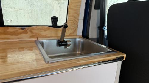 a metal sink in a kitchen in an rv at La Vallena Camper in Madrid