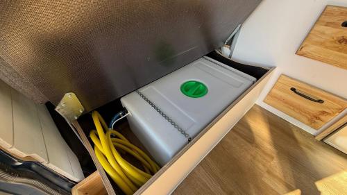 a box with a washing machine in a room at La Vallena Camper in Madrid