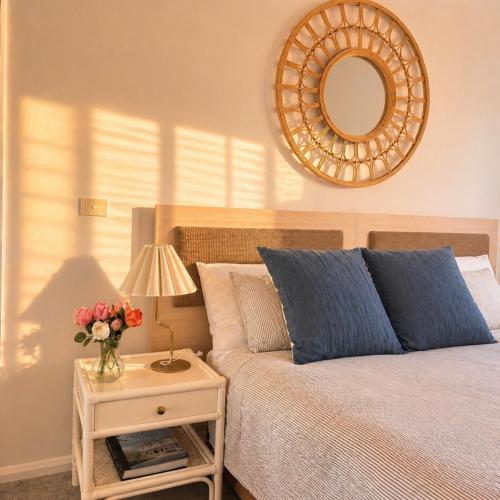 a bedroom with a bed with a table with a mirror at Newly Restyled Resort Studio Oaks Pacific Blue in Salamander Bay