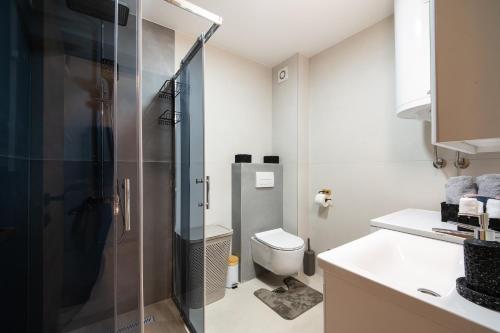 a bathroom with a shower and a toilet at New Modern Apartments with Private Parking in Leštane