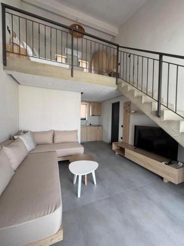 a living room with a couch and a table at Villa Eden in Kallithea Halkidikis