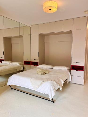 a bedroom with two beds and a large mirror at Hello Bronte! in Sydney