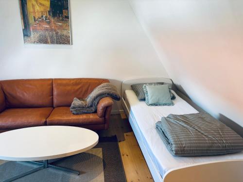 a living room with a couch and a table at Søgården, 3080 Tikøb in Tikøb