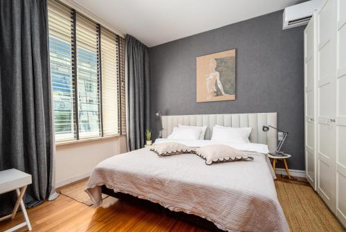 a bedroom with a large bed and a window at Chmielna, Sun&Snow in Warsaw