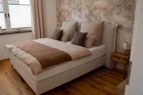 a white bed with pillows in a bedroom at LOFT 21 Rhön in Hofbieber