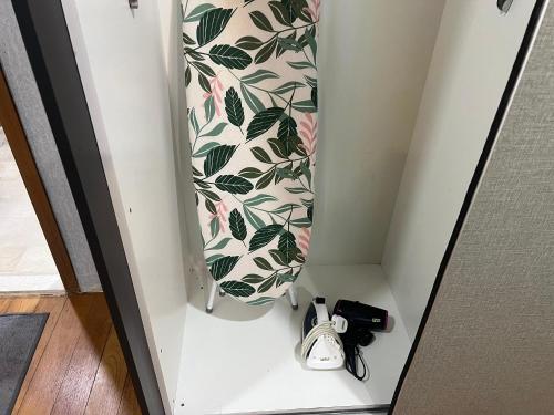 a door with a tie and shoes in a room at VORTEX Suites KLCC Premium BY RRP in Kuala Lumpur