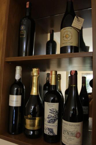 a shelf with bottles of wine on it at Star Hotel in Tirana