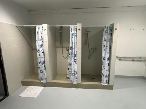 a shower stall with curtains in a bathroom at Ubytovna E75 in Mosty u Jablunkova