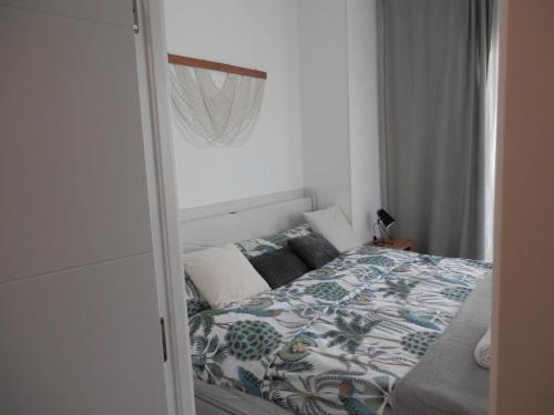 a small bedroom with a bed in a room at Aloha Benidorm in Cala de Finestrat