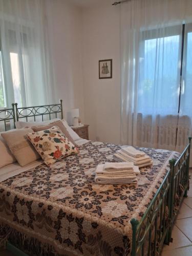 a bedroom with a bed with towels on it at Agriturismo Bellavista in Arsita