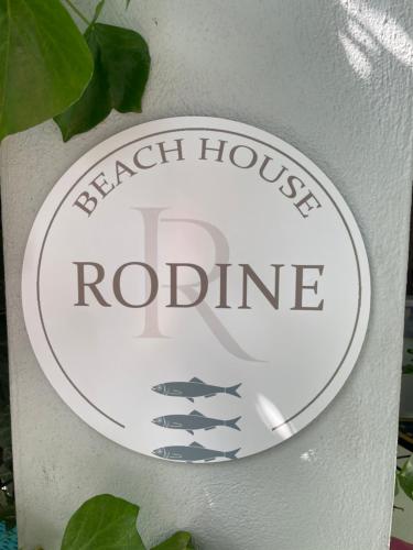 a sign for a black house robinate on a wall at Beach House Rodine - free parking & bikes in Scheveningen