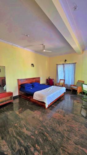 a bedroom with a large bed in a room at Manasthala Brindavan in Mysore