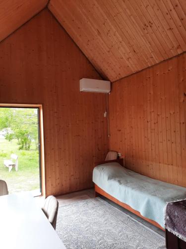 a bedroom with a bed in a room with a window at Perizat in Saty
