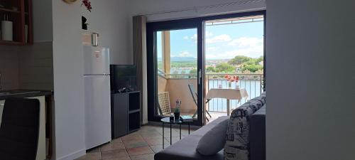 a kitchen with a sliding glass door to a balcony at Apartment Mali Mol in Vantačići