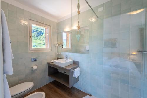 a bathroom with a sink and a toilet at Hotel Hanny Panoramic Views over Bolzano in Bolzano