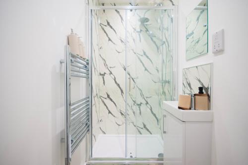 a bathroom with a shower and a sink at Derby Luxury Apartments - Curzon in Derby