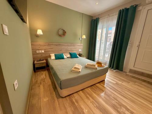 a bedroom with a bed with two towels on it at ΑVLI Sarti Studios & Apartments no1 in Sarti