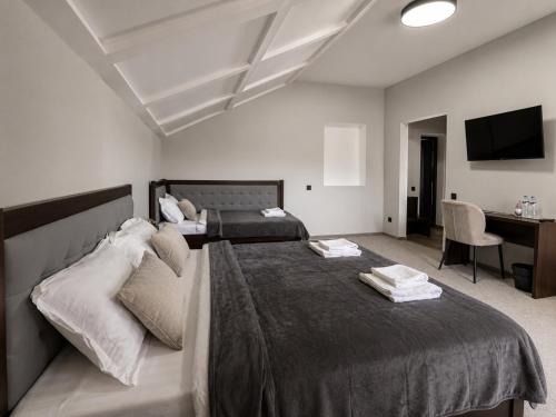 a bedroom with a large bed and a desk at Villa Caza in Chişinău