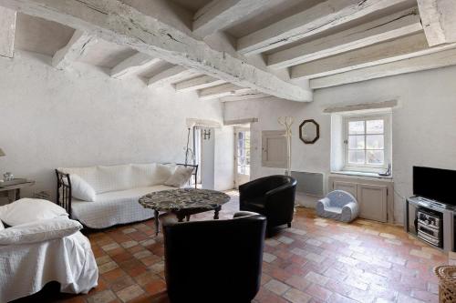 a living room with a couch and a table at La Fromagerie in Mondion