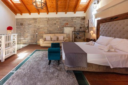a bedroom with a large bed and a couch at Cavour Living – Luxury Design Olbia Centro in Olbia