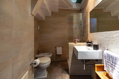 a bathroom with a toilet and a sink at Cavour Living – Luxury Design Olbia Centro in Olbia