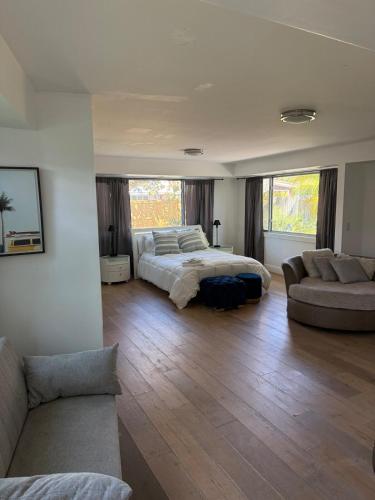 a large bedroom with a bed and a couch at Flip Flops 1 mile beach stadium close in Hollywood