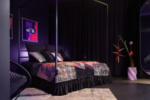 a purple bedroom with a bed with a comforter at Your very unique private spa in Berlin Kreuzberg in Berlin